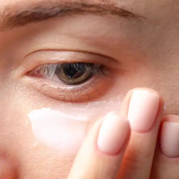 Brown eye with visible eyelashes and eyebrow.