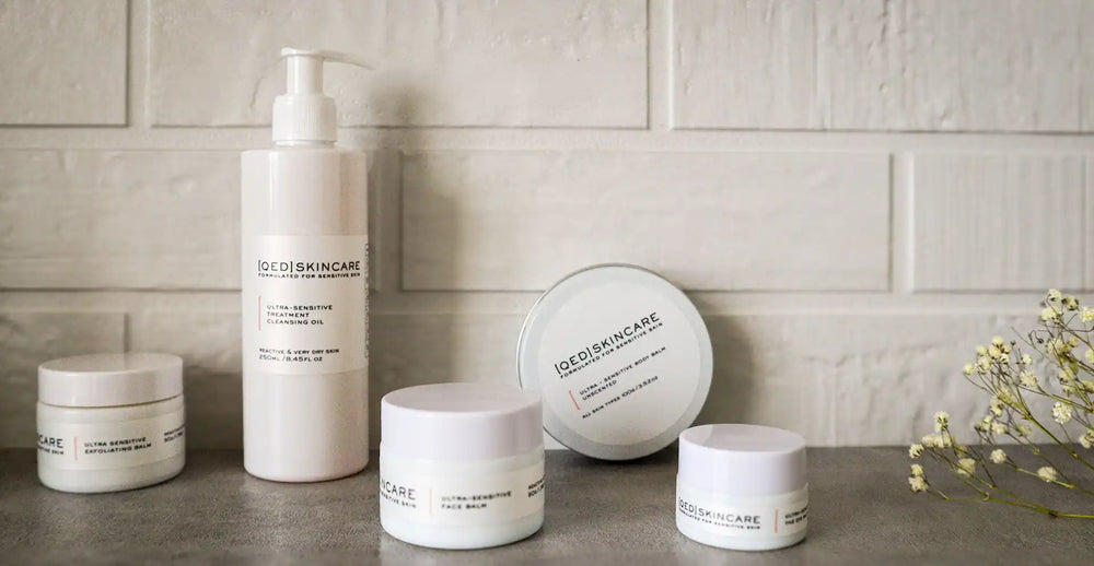 Collection of white skincare products with minimalist packaging.