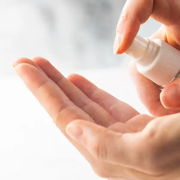 Hand sanitizer or liquid soap being dispensed onto a palm.