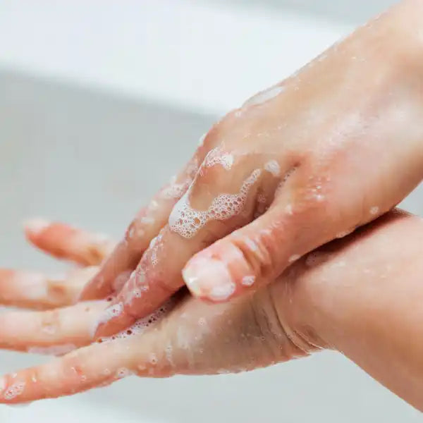 Hands washing with soap and water.