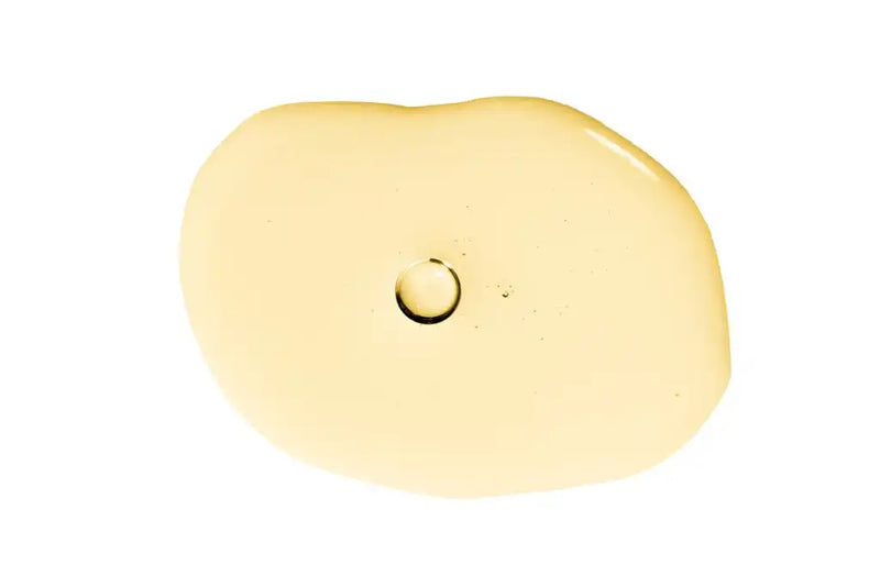 Pale yellow bar of soap with a small circular indentation.