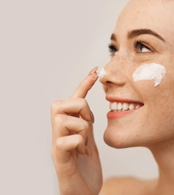 A side profile showing moisturizer being applied to the nose and cheek.