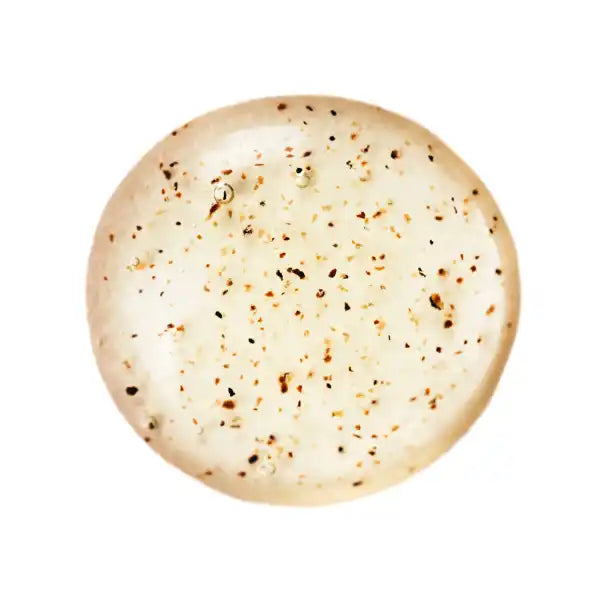 Round flatbread speckled with black and brown seasonings.