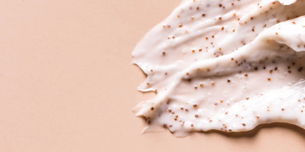 White cream or frosting with tiny brown speckles spread across its surface.